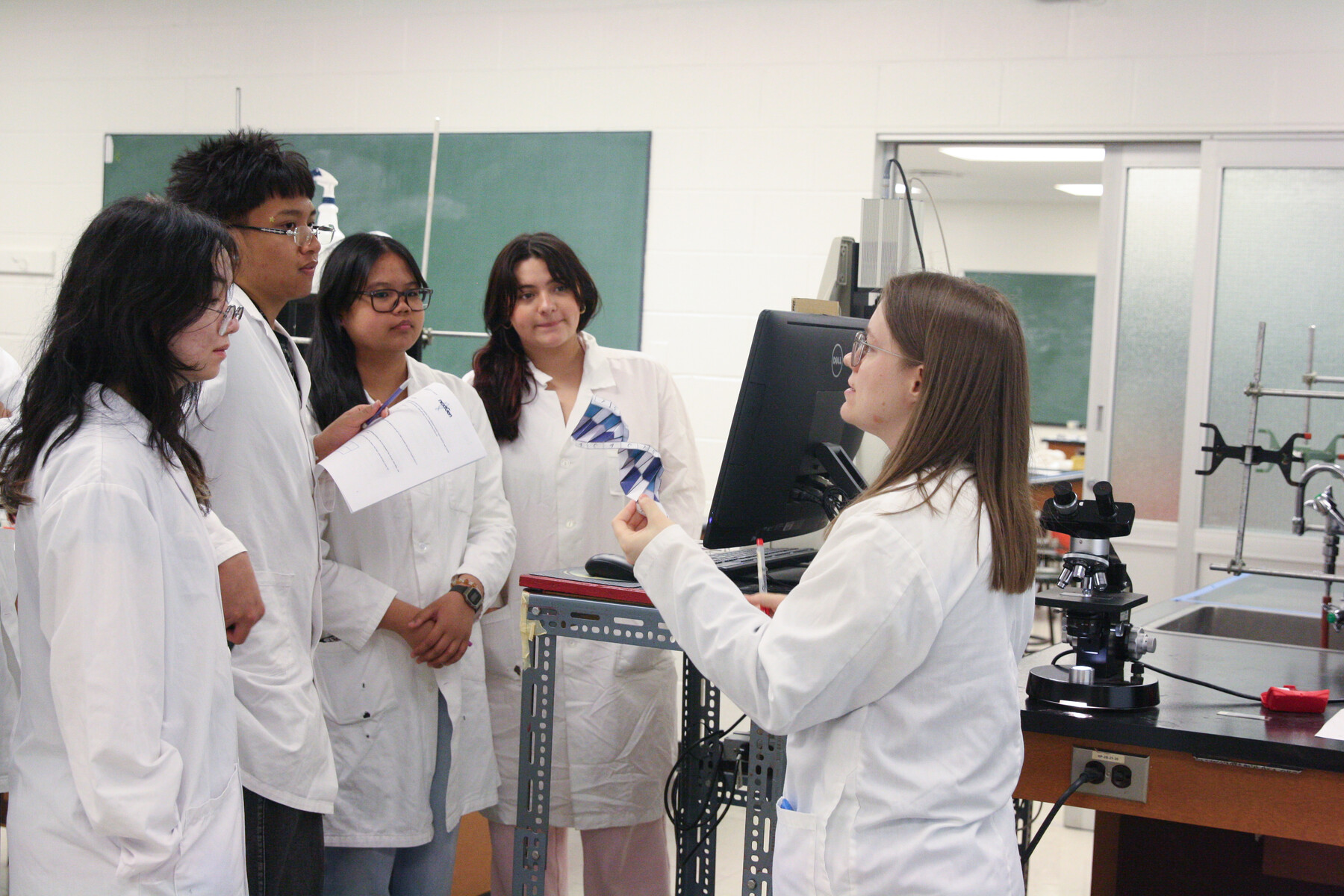 Dr. Campbell showing PCR results to students from James Cardinal McGuigan Catholic School