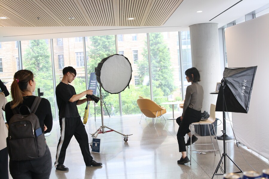 Students lined up to have their portrait taken by photographer Thomas Bui.