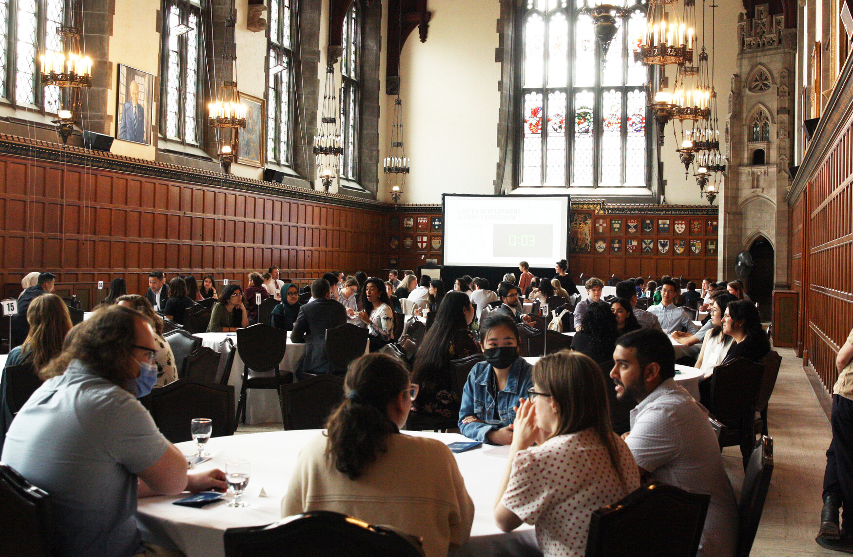 a group of students listening to a presenter speak