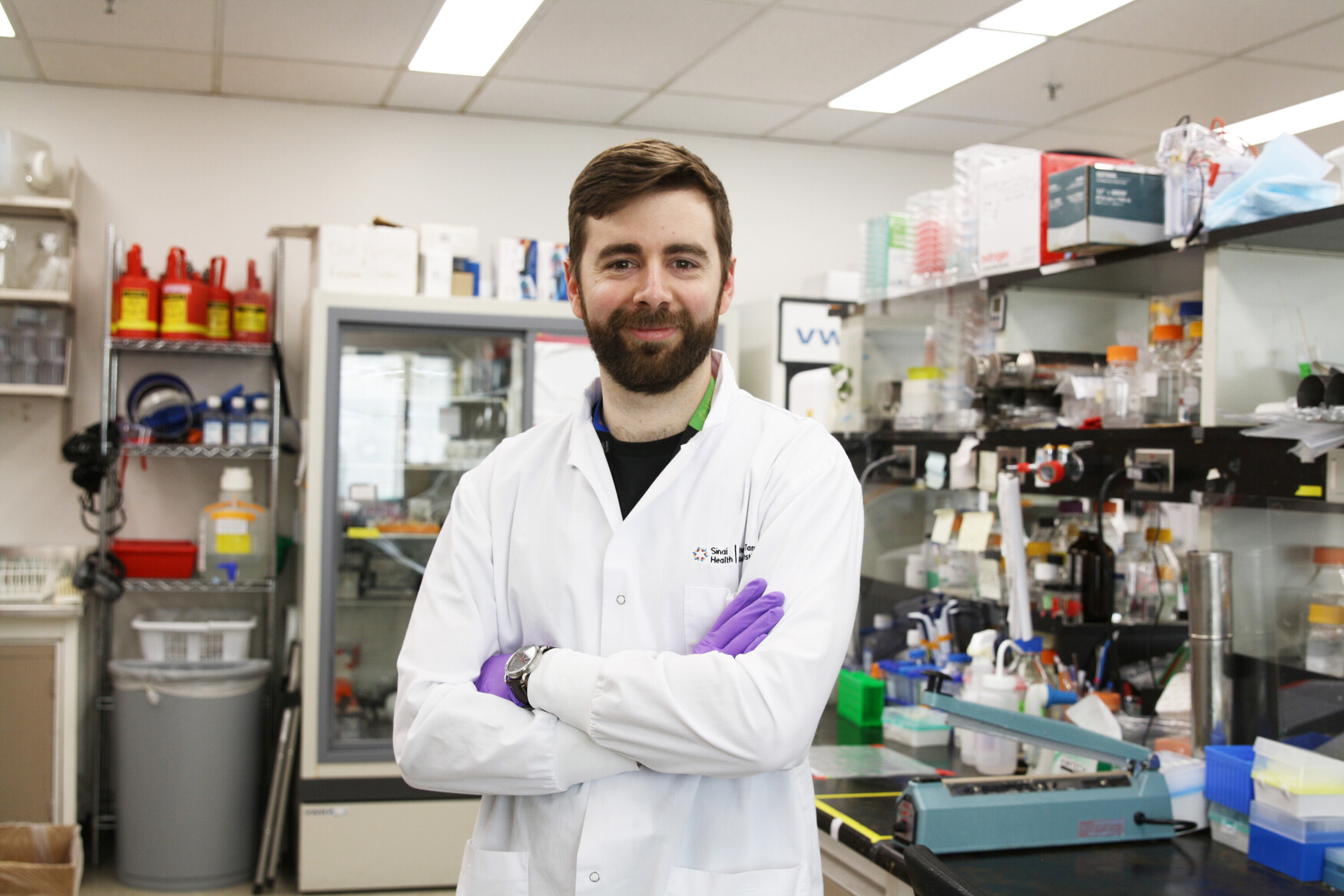 a man with a lab coat in the middle of lab benches