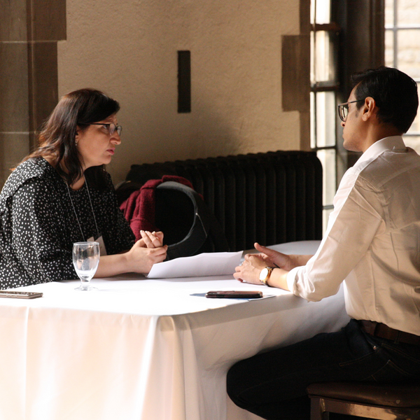 woman speaking to man at table